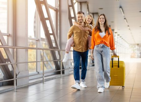 Family,Having,Fun,At,Airport,,Father,Carrying,Daughter,On,Back