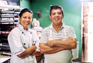 Father and daughter portrait in their small bakery in Mexico.